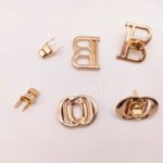Wholesale New Design Letter Hollowed-Out Metal Turn Locks Custom Brand Letter Logo Push Twist Lock for Bag Accessories