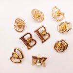 Wholesale New Design Letter Hollowed-Out Metal Turn Locks Custom Brand Letter Logo Push Twist Lock for Bag Accessories
